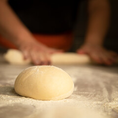 person kneading dough