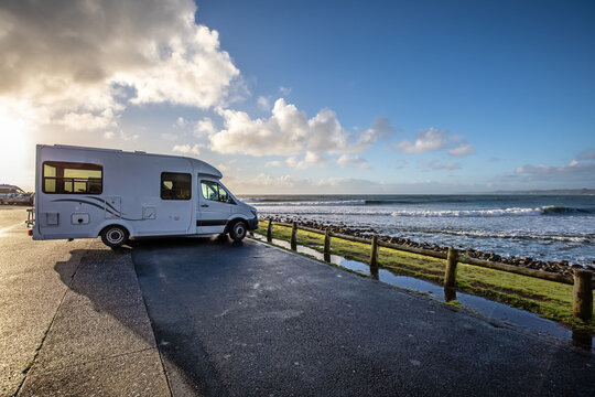 Motorhome at sunset parked in front of perfect waves