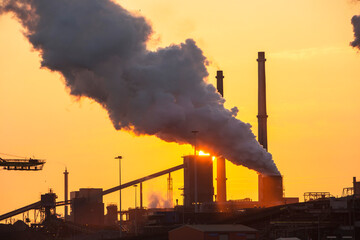 Emissions from a Tata steel works in Ijmuiden, Netherlands, at sunset.