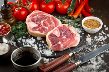 Raw meat with spices in a composition with kitchen accessories.