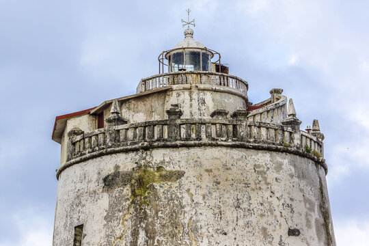 Famous Lighthouse at Fort Aguada - well-preserved (1613) Portuguese fort. Fort Aguada standing on Sinquerim Beach at shore of the Mandovi River, overlooking Arabian Sea. Goa, India.