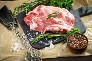 Raw meat with spices in a composition with kitchen accessories.