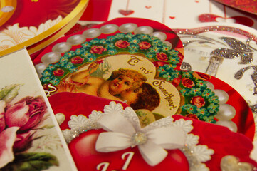Obraz na płótnie Canvas Close-up of a red valentine with a pattern of 2 angels on a background of valentines side view