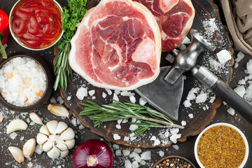 Raw meat with spices in a composition with kitchen accessories.