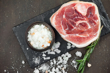 Raw meat with spices in a composition with kitchen accessories.