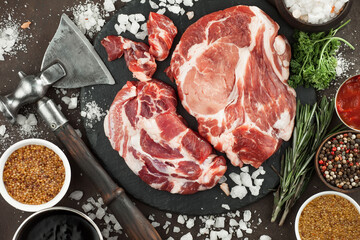 Raw meat with spices in a composition with kitchen accessories.