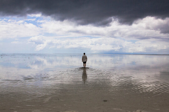man walking on crystalline water mirror in virgin island Philippines