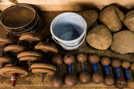 High angle view of weights with bucket and sieves in sumo beya