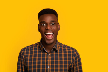Closeup Portrait Of Excited African American Guy Looking At Camera With Amazement