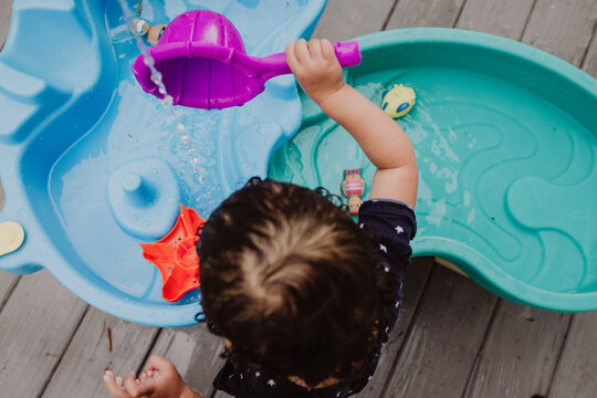 Child playing with water table