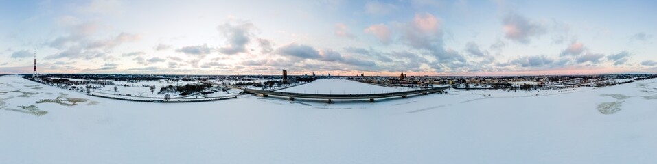Aerial panorama view of Riga during beautiful winter sunset in Latvia. Super wide drone view