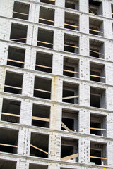 New unfinished multistorey white brick building, copy space