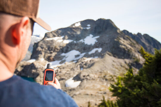 Mountaineer navigates using a GPS device.