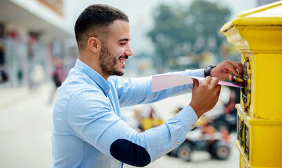 Young man sending a folder and documents via mailbox. Business, lifestyle concept