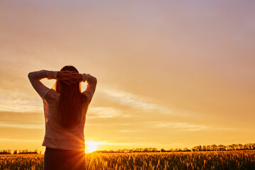 silhouette of happy young woman on sunset