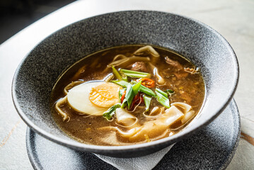 asian soup with noodles and egg