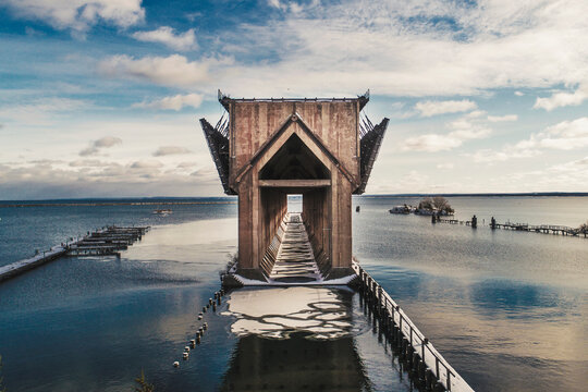 Ore dock by Lake Superior against cloudy sky during winter