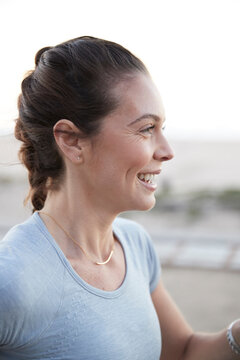 Side view of cheerful woman exercising outdoors