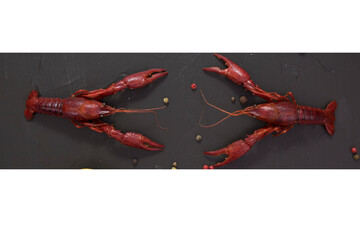 Delicious boiled crayfish close-up on a stone plate with lemon and parsley, free space for your text, collages, in Black background,