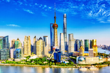 Shanghai city skyline with huangpu river. Pudong business district in Shanghai, China with blue sky during summer sunny day.