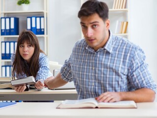 Students sitting and studying in classroom college