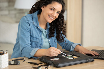 female engineer repairs laptop support fixing notebook computer