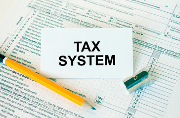 Obraz premium Business card with text Tax System on financial docs