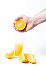 A man squeezes a fresh orange with his hands and gets natural juice