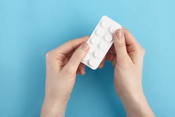 White blister pack of medicine pills in a hands. Heap of pills - medical background