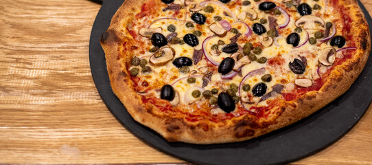 pizza with olives, anchovies, and red onions