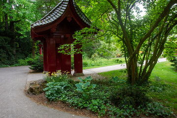 Fototapeta na wymiar Gate Torii (side look ) and naturew in japanese garden in japanese garden in Leverkusen , north Rhine-Westphalia
