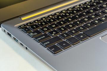 laptop lying on the desk and next to it samples, fabrics, veneers, wood, stone