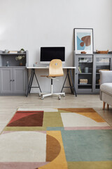 Vertical background image of minimal interior with focus on modern home workplace, copy space