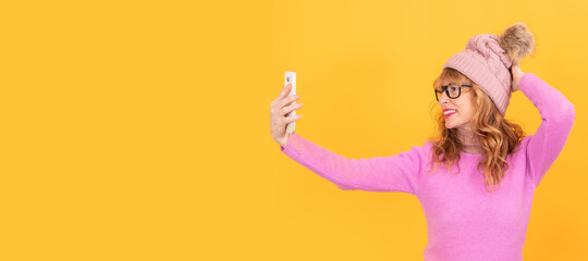 Fototapeta na wymiar adult woman taking a selfie with the phone isolated on background