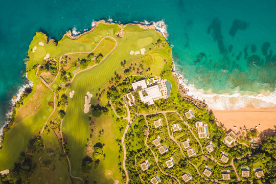 Aerial view of a luxury resort facing the Ocean with waves crashing on the beach on a paradise island, Mar&iacute;a Trinidad S&aacute;nchez, Dominican Republic.