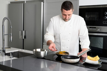 Concentrated at work. Portrait of handsome professional chef working in restaurant kitchen. High quality photo