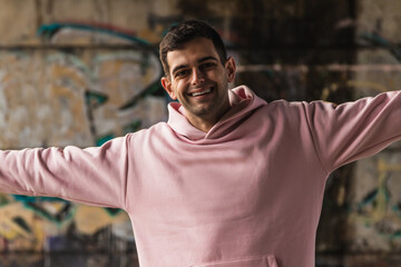 happy young man on the street with open arms