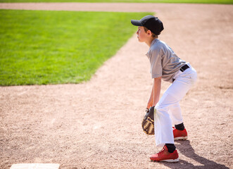 Young boy playing first base in a baseball game