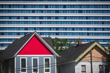 Colorful old fashioned houses with a modern commercial building filling the background