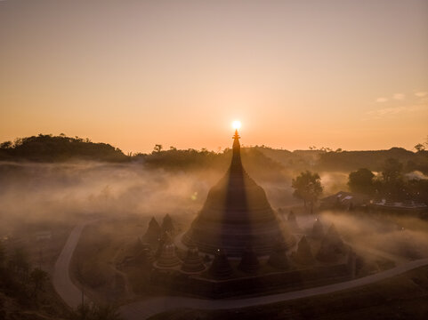 Aerial view of Shin Mra War Pagoda on hilltop during a beautiful foggy sunset, Mrauk-U Township, Myanmar.