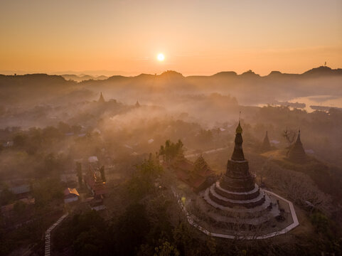 Aerial view of Shin Mra War Pagoda on hilltop during a beautiful foggy sunset, Mrauk-U Township, Myanmar.
