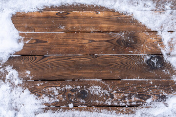 Winter background. Empty wooden plank with snowy border, copy space for text Wood table. For...