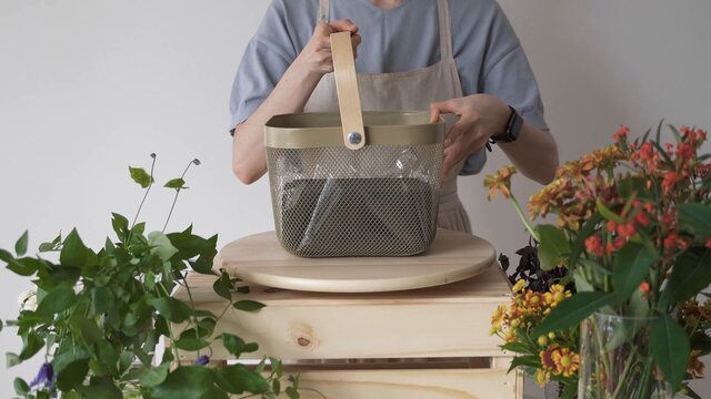 Mujer Levantando Una Bolsa De Plástico. Arreglos Florales