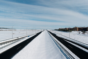 Fototapeta na wymiar snowy highway recently cleared by snowplows