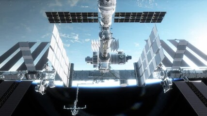 The International Space Station orbiting above the Earth glowing in the sunset, complete with mountains and clouds