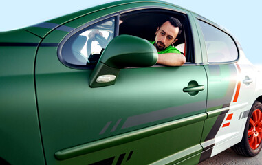 man looking in the rearview mirror of his car