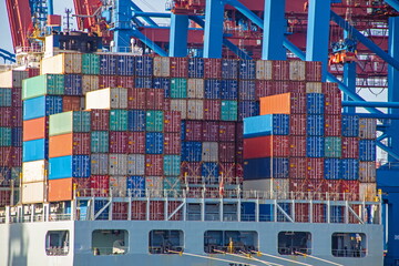 Container ship with colorful containers on the vessel quayside in the freight terminal of the...