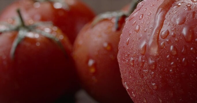 Juicy red ripe tomatoes on chef's table. Freshly washed organic vegetables. Water drops slowly falling from nutritious fruit close up shot 4k footage