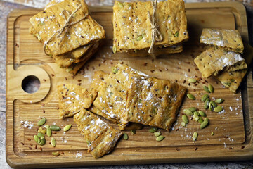 Selective focus. Homemade fitness cookies on a wooden board. Healthy biscuits with seeds.