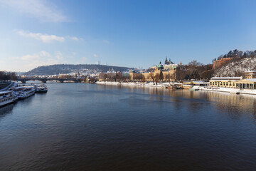 Snowy Prague Lesser Town with Prague Castle above River Vltava in the sunny Day , Czech republic